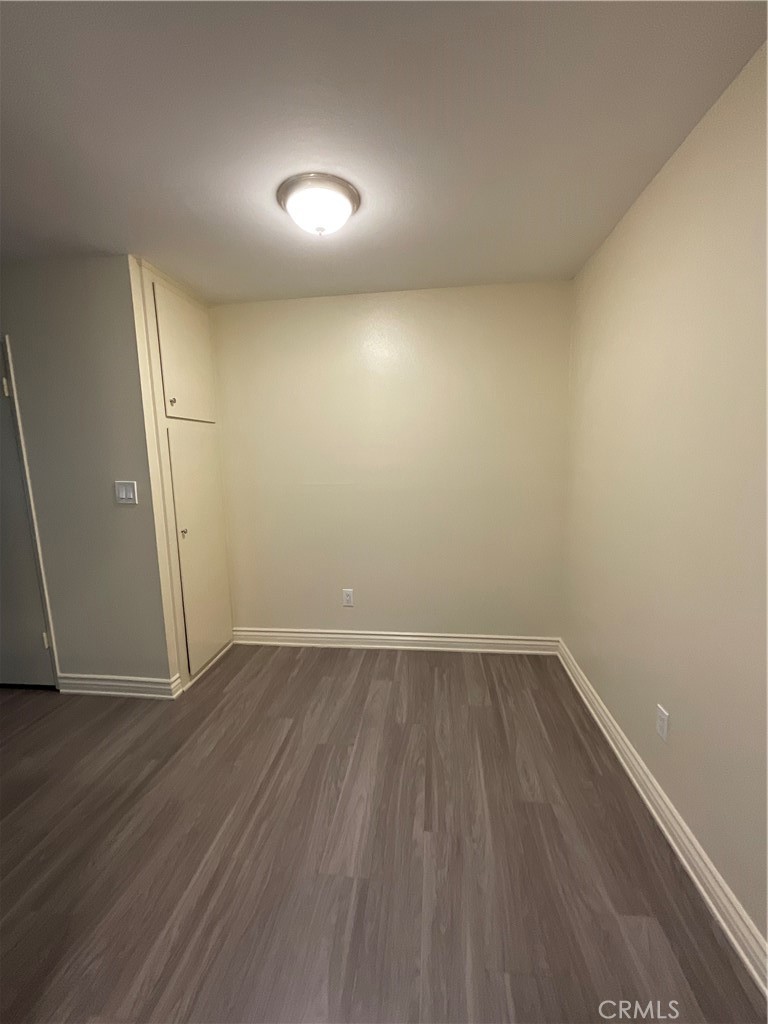 6042 Lime Avenue, Unit B Cypress, CA 90630 - Photo 9 of 20 an empty room with wooden floor and white walls