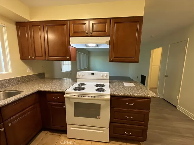 a kitchen with a stove and a refrigerator