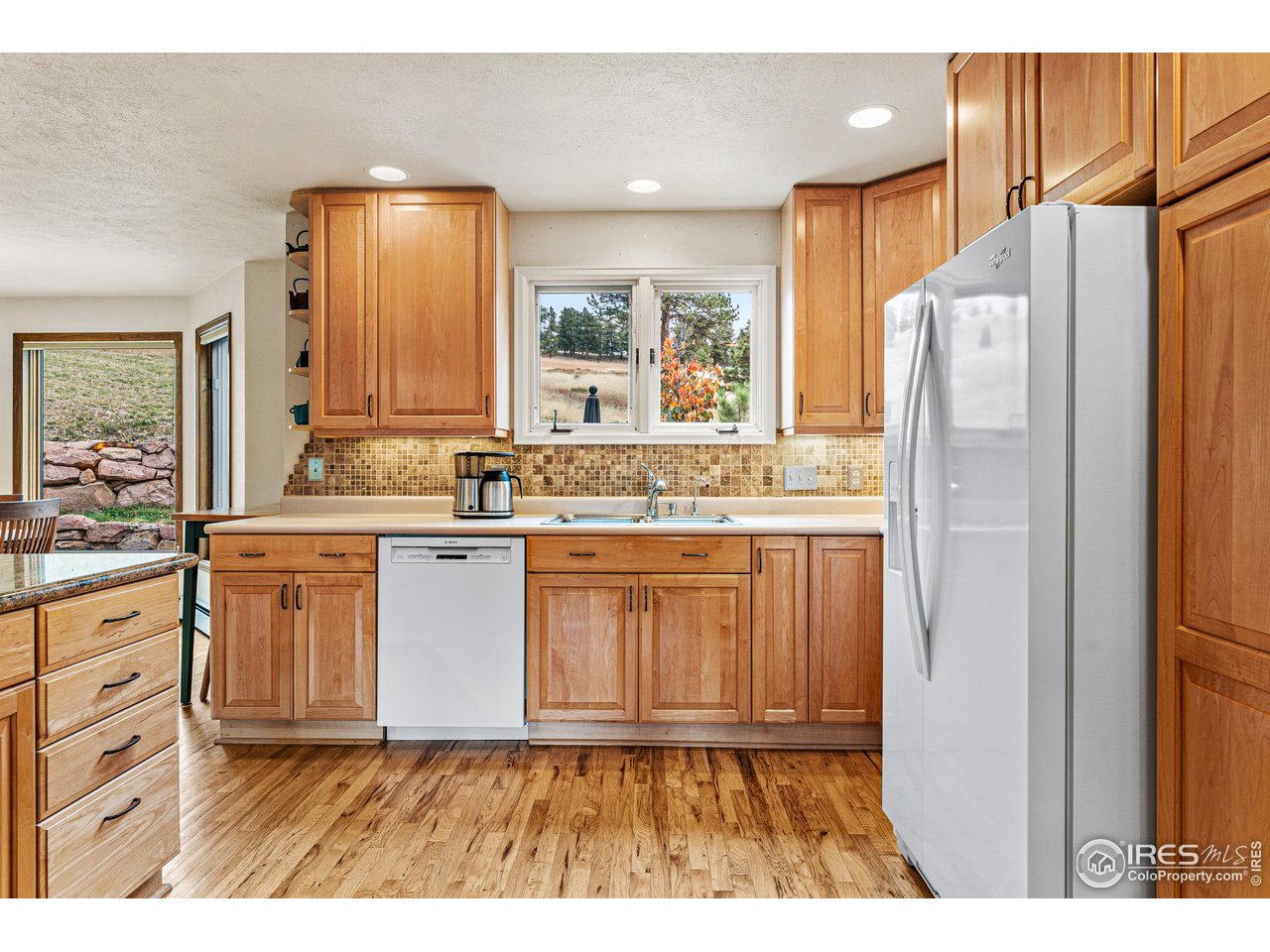297 Broken Fence Road Boulder, CO 80302 - Photo 14 of 39 Slab granite countertops, Bosch HE Dishwasher (2017) Whirlpool Refrigerator (2017), and reverse Osmosis Water filtration system