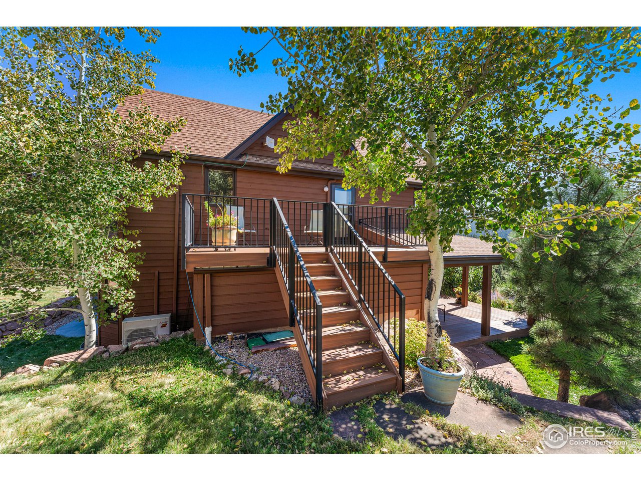 297 Broken Fence Road Boulder, CO 80302 - Photo 28 of 39 Newer (2018) Trex deck and iron custom railing off of upstairs Primary Bedroom
