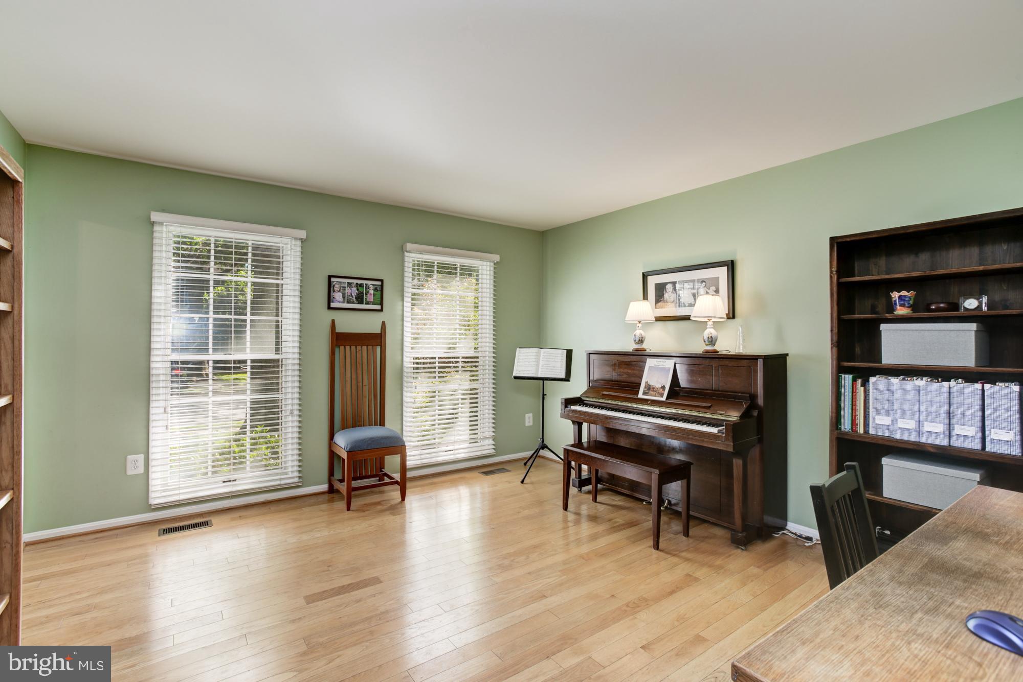 326 Riding Ridge Road Annapolis, MD 21403 - Photo 7 of 63 a living room with furniture and a piano next to a large window