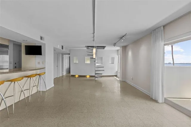 a view of a livingroom with furniture and a window