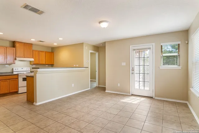 a view of a kitchen with microwave and cabinets