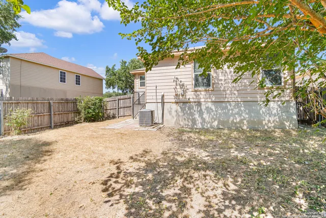 a white house that has a tree in front of it