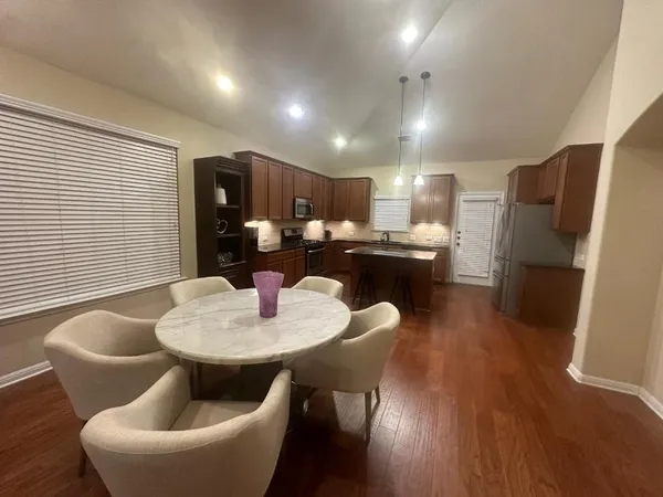 a dining room with furniture and wooden floor