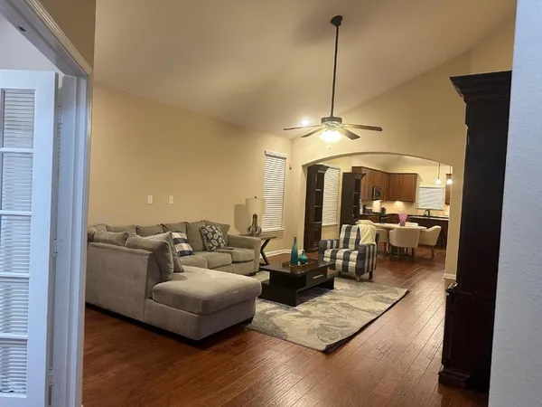 a living room with furniture and a chandelier