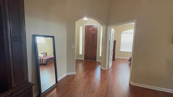 a view of a hallway with wooden floor