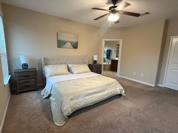 a bedroom with a bed and a chandelier