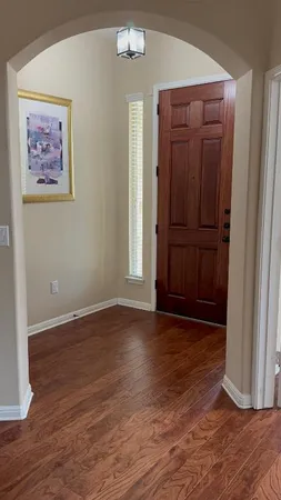 an empty room with wooden floor and closet