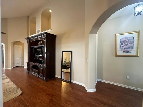 a living room with furniture and a wooden floor