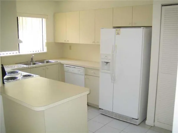a white refrigerator freezer sitting inside of a kitchen