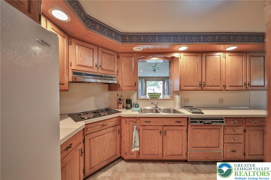141 East Berger Street Emmaus, PA 18049 - Photo 11 of 49 a kitchen with a sink a stove cabinets and a window