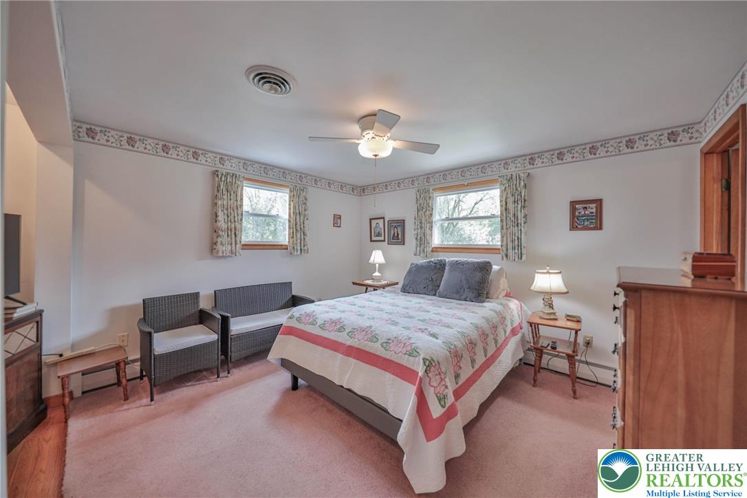 141 East Berger Street Emmaus, PA 18049 - Photo 17 of 49 a spacious bedroom with a bed and a chandelier