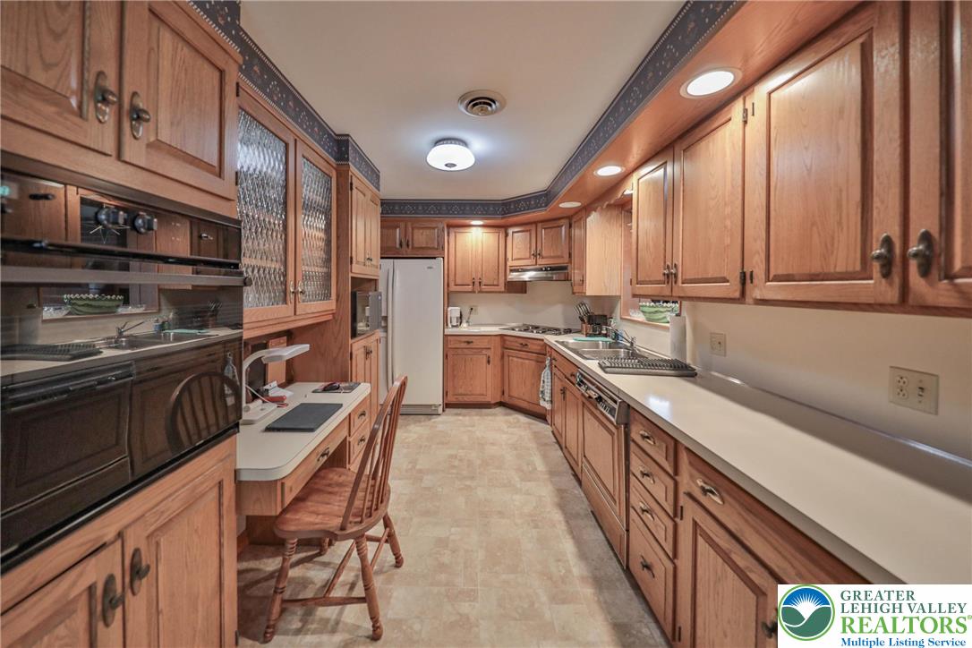 141 East Berger Street Emmaus, PA 18049 - Photo 9 of 49 a kitchen with stainless steel appliances a sink window and cabinets