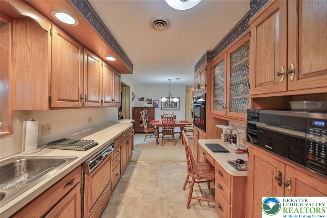 141 East Berger Street Emmaus, PA 18049 - Photo 10 of 49 a kitchen with stainless steel appliances granite countertop sink stove and cabinets