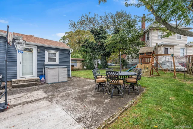 a view of a house with a backyard and a patio