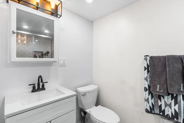a bathroom with a toilet sink and mirror