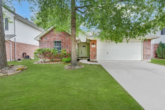 a front view of house with yard and green space