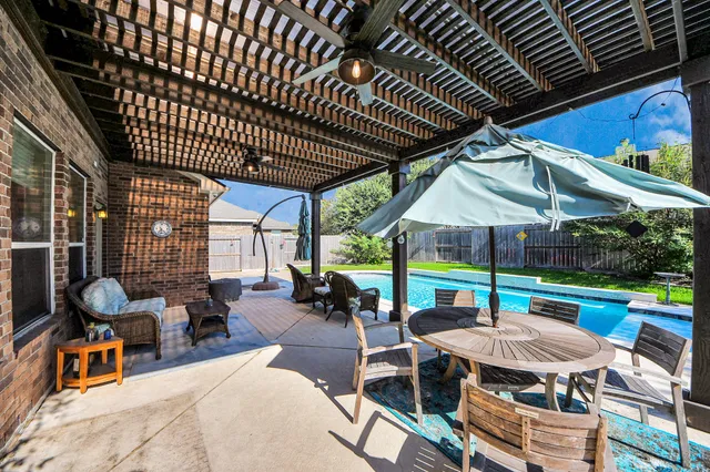 an outdoor space with furniture and umbrella