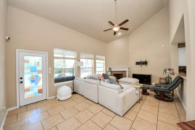 a living room with furniture and a floor to ceiling window