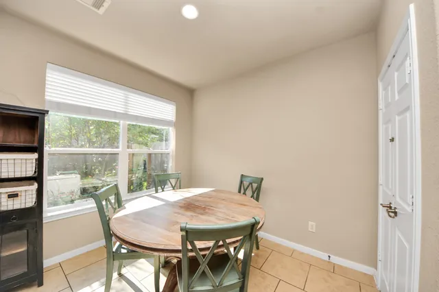 a dining room with furniture and window