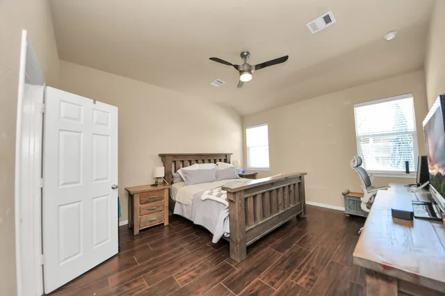 a bedroom with a bed and a large window