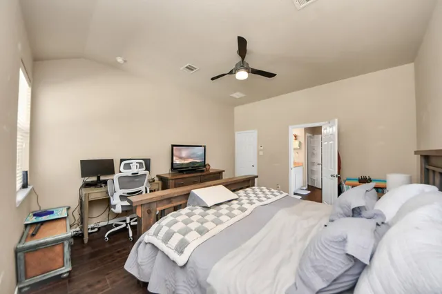 a bedroom with a bed a desk and chair