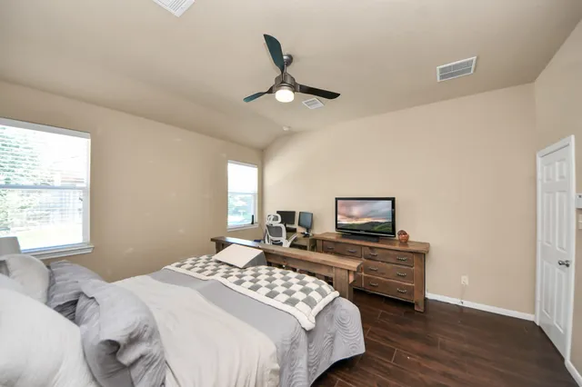 a bedroom with bed and a window