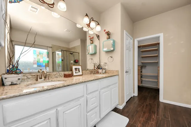 a bathroom with a double vanity sink and a mirror
