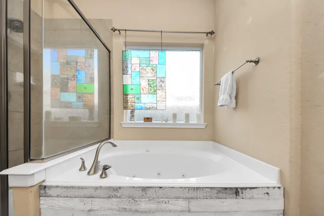 a bathroom with a bathtub and shower