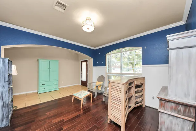 a view of a livingroom with furniture window and wooden floor