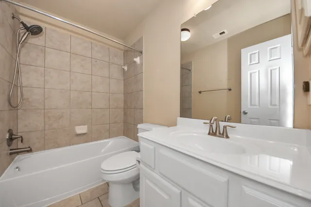 a bathroom with a sink a toilet and bathtub