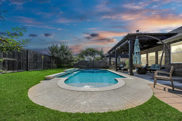 a view of a backyard with sitting area