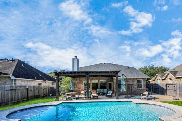 a front view of a house with garden and trees