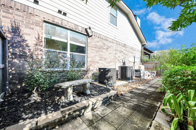 a view of backyard with wheel chair potted plants and large tree