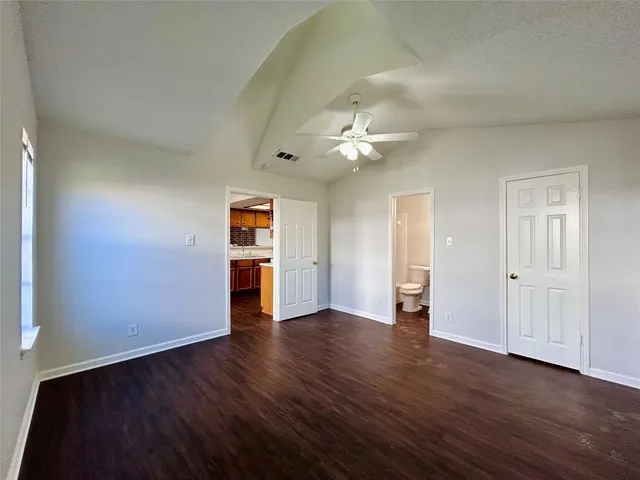 an empty room with wooden floor and window