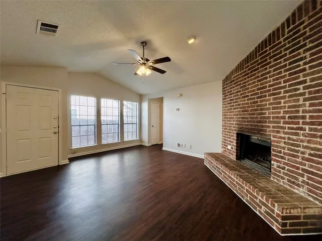 wooden floor in an empty room with a fireplace