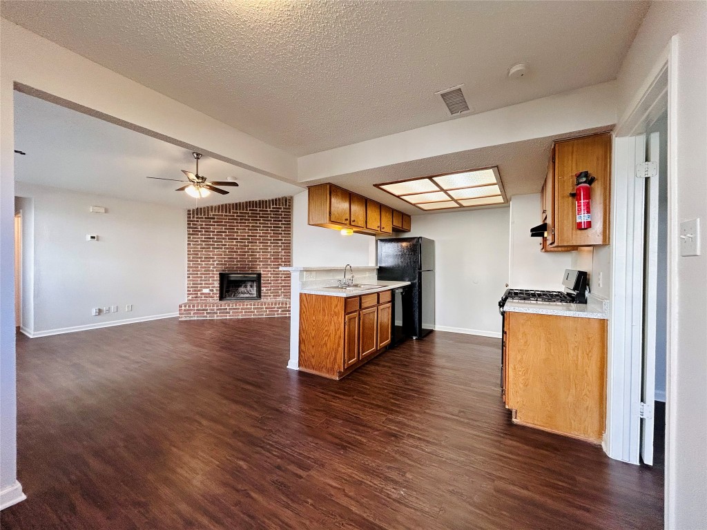 9317 Kempler Drive, Unit A Austin, TX 78748 - Photo 9 of 15 a kitchen with stainless steel appliances a refrigerator and a stove top oven