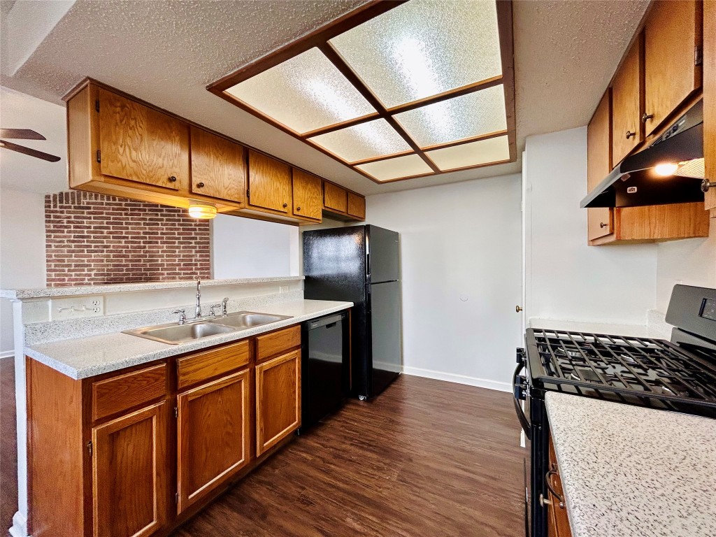 9317 Kempler Drive, Unit A Austin, TX 78748 - Photo 10 of 15 a kitchen with a sink stove and cabinets