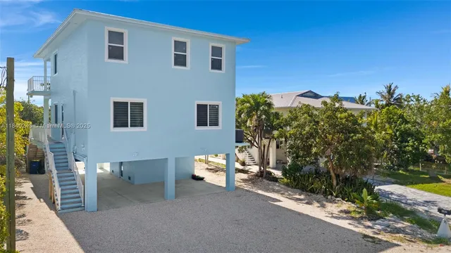 an aerial view of a house with a lake view
