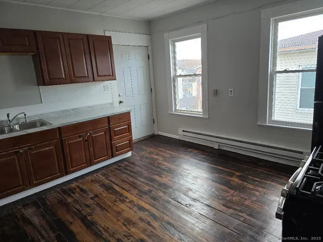 a kitchen with wooden cabinets and sink
