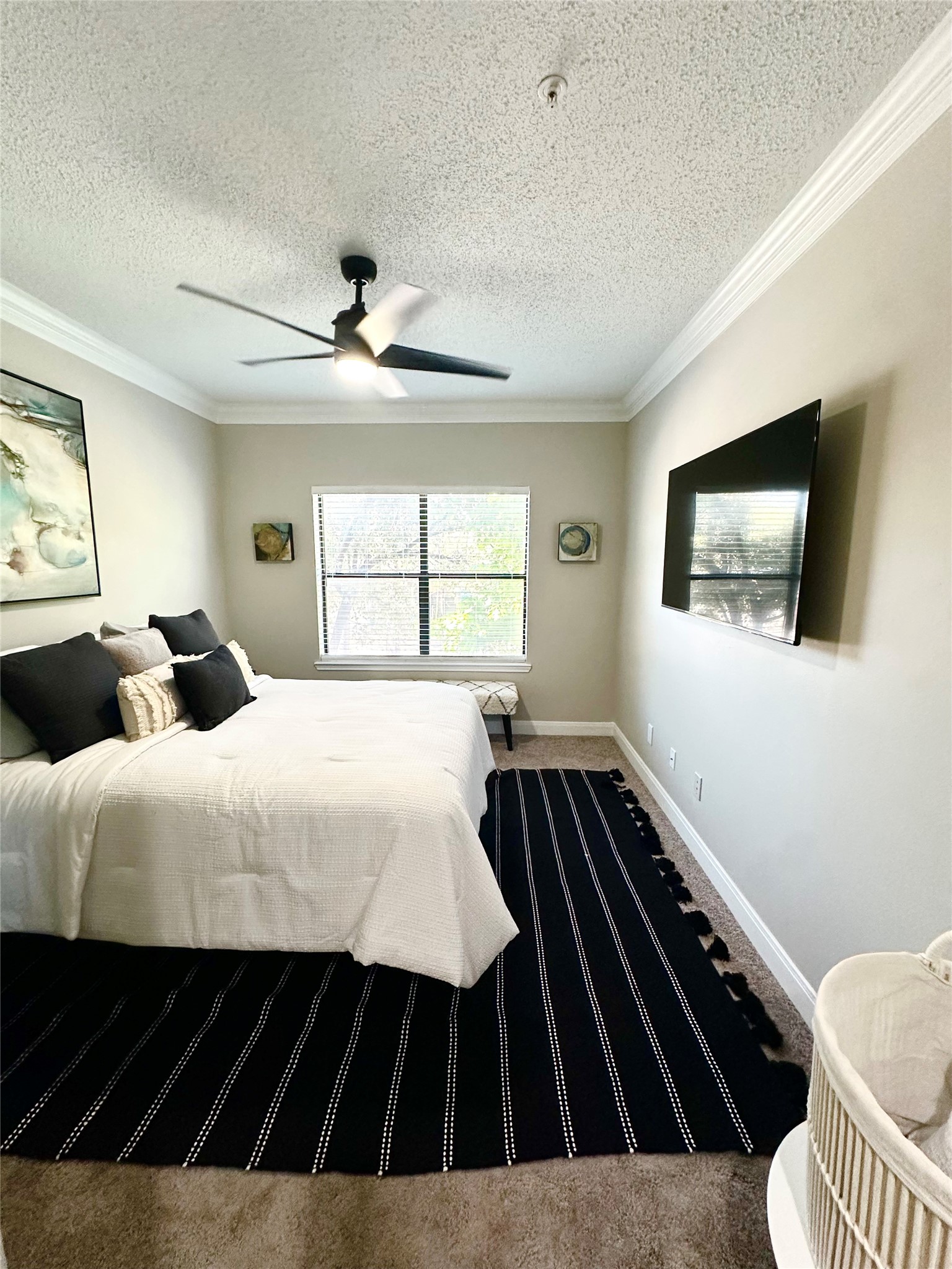 2345 Sage Road, Unit 143 Houston, TX 77056 - Photo 11 of 19 a bedroom with a large bed and a flat tv screen on dresser