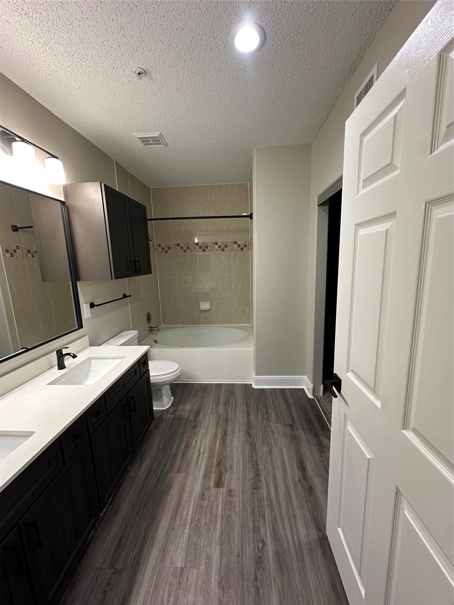 2345 Sage Road, Unit 143 Houston, TX 77056 - Photo 12 of 19 a bathroom with a sink a toilet a mirror and shower
