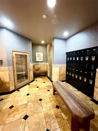 a large bedroom with a bed and wooden floor