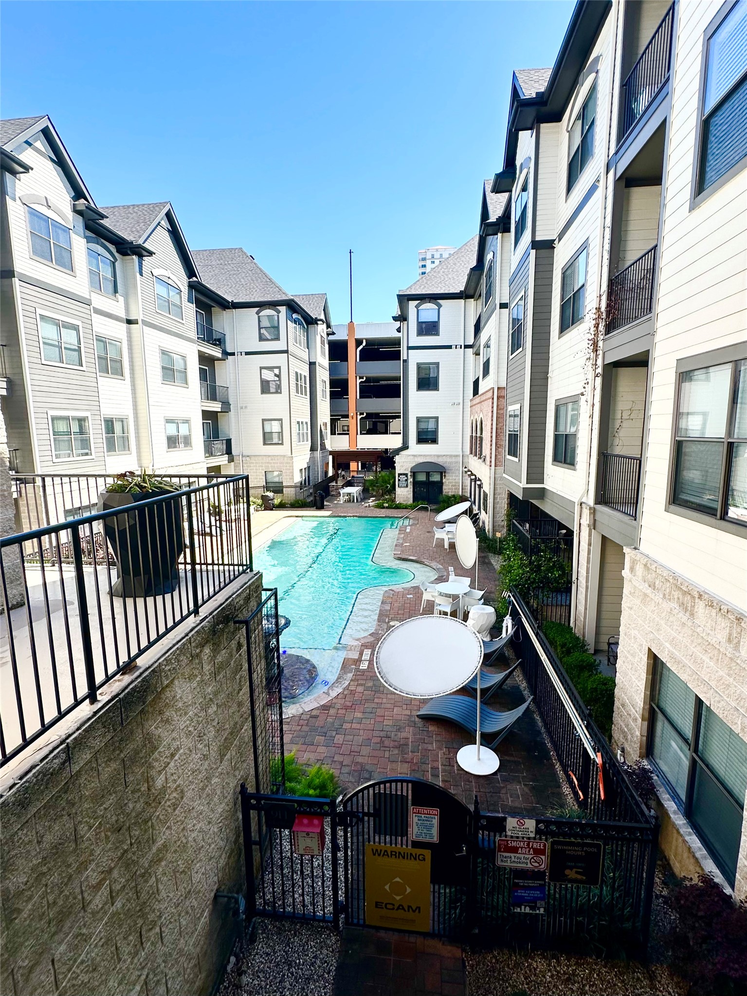 2345 Sage Road, Unit 143 Houston, TX 77056 - Photo 16 of 19 a view of a patio with table and chairs with wooden floor and fence