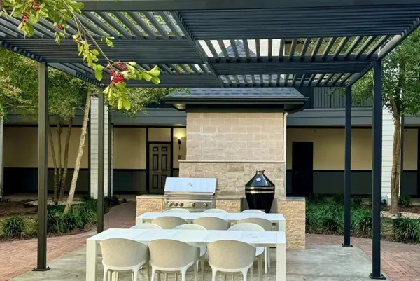 a view of a patio with table and chairs and potted plants