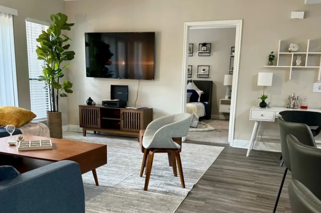 2345 Sage Road, Unit 143 Houston, TX 77056 - Photo 3 of 19 a living room with furniture and a flat screen tv