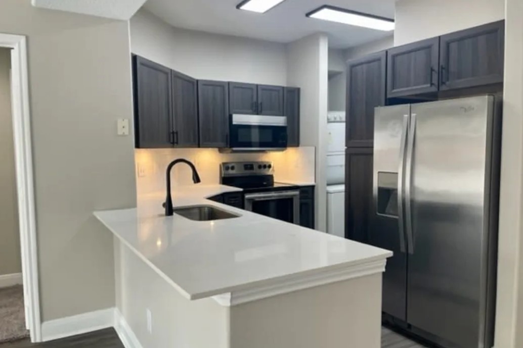 2345 Sage Road, Unit 143 Houston, TX 77056 - Photo 4 of 19 a kitchen with refrigerator and a sink