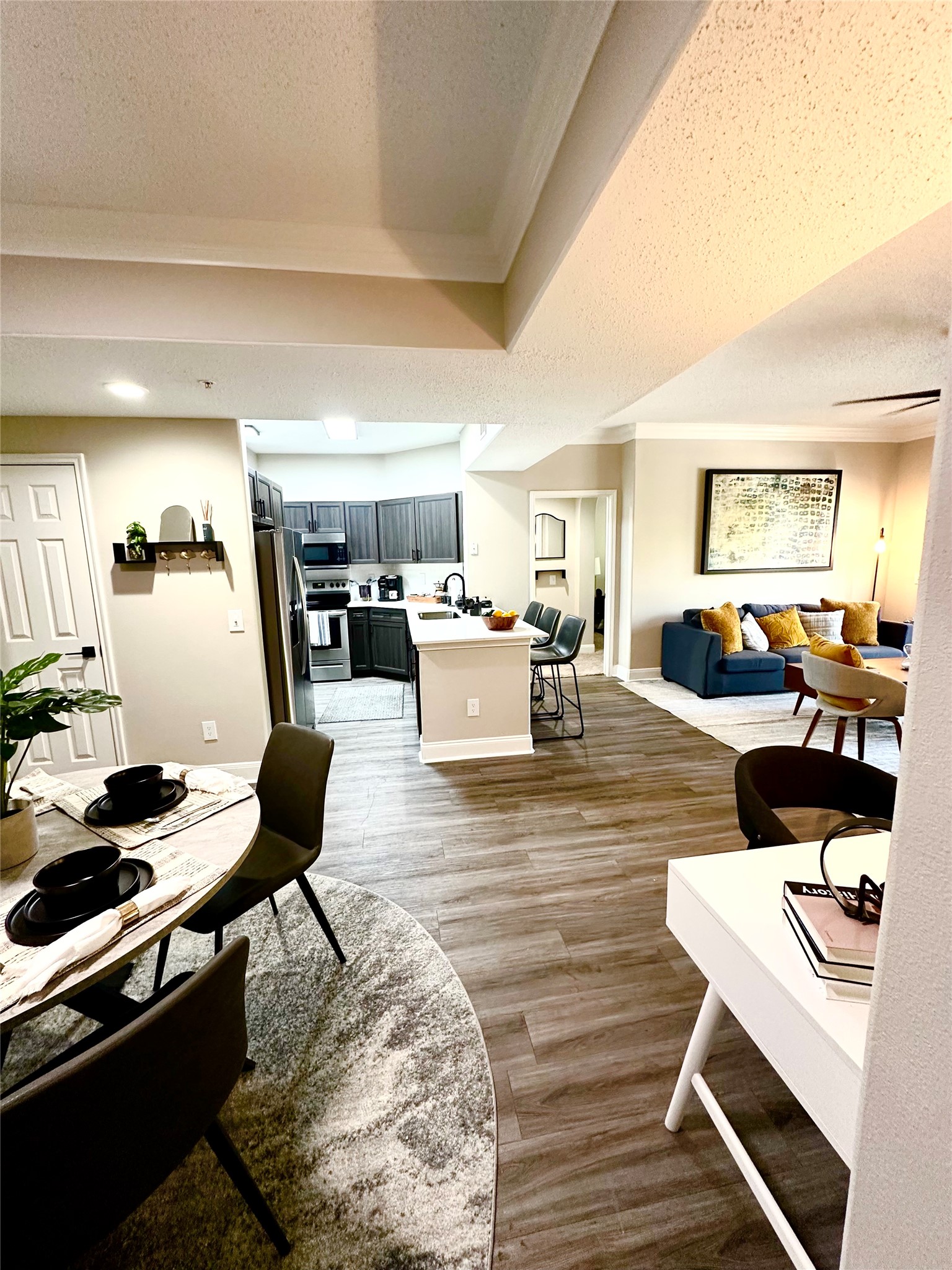 2345 Sage Road, Unit 143 Houston, TX 77056 - Photo 6 of 19 a living room with furniture and a dining table with kitchen view
