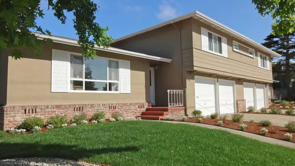 a front view of a house with a yard